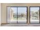 Exterior view from the living room with sliding glass doors and neutral carpet at 532 Greenbriar Pl, Boulder City, NV 89005