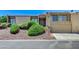 Two-story home featuring desert landscaping, a two-car garage and a quaint balcony area at 532 Greenbriar Pl, Boulder City, NV 89005