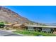 Charming front exterior of a house with mature trees and landscaping at 532 Greenbriar Pl, Boulder City, NV 89005