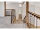 Second floor landing with railing, neutral carpet and views to the lower level at 532 Greenbriar Pl, Boulder City, NV 89005