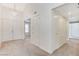 Hallway featuring multiple doors, neutral carpet and natural lighting at 532 Greenbriar Pl, Boulder City, NV 89005