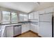 Kitchen with granite countertops, stainless appliances, white cabinets and natural light at 532 Greenbriar Pl, Boulder City, NV 89005