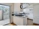 Bright kitchen featuring granite countertops, white cabinets, stainless appliances, and backyard access at 532 Greenbriar Pl, Boulder City, NV 89005