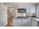 Bright kitchen features white cabinetry, stainless steel appliances, and a granite countertop at 532 Greenbriar Pl, Boulder City, NV 89005