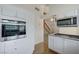 Bright kitchen boasts white cabinetry, stainless steel appliances, and a granite countertop at 532 Greenbriar Pl, Boulder City, NV 89005