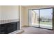 Bright living room featuring a tile fireplace and large sliding glass doors to the outside patio at 532 Greenbriar Pl, Boulder City, NV 89005