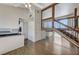 Bright living area with wood flooring, natural light, and a wooden staircase at 532 Greenbriar Pl, Boulder City, NV 89005