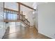 Open-concept living area with a wooden staircase and light-colored wood floors at 532 Greenbriar Pl, Boulder City, NV 89005