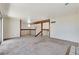 Spacious living room with neutral carpet, wooden beams, and staircase at 532 Greenbriar Pl, Boulder City, NV 89005