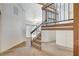 Carpeted staircase with wood and iron railing leading to the home's second floor living spaces at 532 Greenbriar Pl, Boulder City, NV 89005