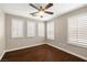 This bedroom features hardwood floors, a ceiling fan, and window shutters at 5695 Merced St, Las Vegas, NV 89148