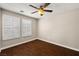Bedroom with hardwood floors, ceiling fan, and window shutters at 5695 Merced St, Las Vegas, NV 89148