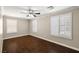 Bedroom with hardwood floors, window shutters, and a ceiling fan at 5695 Merced St, Las Vegas, NV 89148