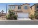Well-maintained two-story home featuring a two-car garage, neutral color palette, and manicured landscaping at 5695 Merced St, Las Vegas, NV 89148