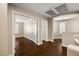 Upstairs hallway with hardwood flooring, neutral walls, and multiple entry doors at 5695 Merced St, Las Vegas, NV 89148