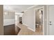 Hallway with tile floors, white trim, fresh paint and doorways leading to the bathroom and living room at 5695 Merced St, Las Vegas, NV 89148