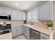 Bright kitchen with stainless steel appliances, neutral countertops, and recessed lighting at 5695 Merced St, Las Vegas, NV 89148