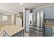 Updated kitchen with stainless steel appliances, island, and access to living area and stairs at 5695 Merced St, Las Vegas, NV 89148