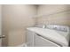 Laundry room with washer, dryer, and storage shelving at 5695 Merced St, Las Vegas, NV 89148