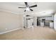 Open-concept living room and kitchen with tile flooring, modern ceiling fan, and updated finishes at 5695 Merced St, Las Vegas, NV 89148