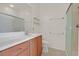 Bathroom features a single sink, wood cabinets, tile floor and shower with glass doors at 6039 Tokara Ave, Las Vegas, NV 89122