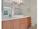 Bathroom features double sinks, wood cabinets, tile floor and shower with glass doors at 6039 Tokara Ave, Las Vegas, NV 89122