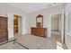 Bedroom with wood floors, neutral walls, and doors to a bathroom and closet at 6039 Tokara Ave, Las Vegas, NV 89122