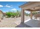 Covered patio provides a comfortable space for outdoor dining and relaxation with low maintenance landscape at 6039 Tokara Ave, Las Vegas, NV 89122