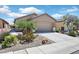Charming single-story home featuring a well-manicured yard with desert landscaping and an attached two-car garage at 6039 Tokara Ave, Las Vegas, NV 89122