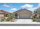 Charming single-story home featuring a well-manicured yard with desert landscaping and an attached two-car garage at 6039 Tokara Ave, Las Vegas, NV 89122