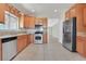 Traditional kitchen with granite countertops, stainless steel appliances, wood cabinets and tile flooring at 6039 Tokara Ave, Las Vegas, NV 89122
