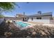 The backyard features a rectangular pool, privacy walls, and low-maintenance desert landscaping at 616 Fernbrook Dr, Henderson, NV 89002