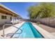 A refreshing in-ground pool is surrounded by concrete and desert landscaping, perfect for relaxation at 616 Fernbrook Dr, Henderson, NV 89002