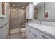 Contemporary bathroom featuring a walk-in shower, marble countertops, and a white vanity at 616 Fernbrook Dr, Henderson, NV 89002