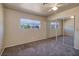 Carpeted bedroom featuring mirrored closet doors, a ceiling fan, and a bright window at 616 Fernbrook Dr, Henderson, NV 89002