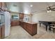 Open kitchen and living area with granite countertops and modern appliances at 616 Fernbrook Dr, Henderson, NV 89002