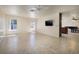Spacious living area featuring tile floors, large windows and a ceiling fan at 616 Fernbrook Dr, Henderson, NV 89002