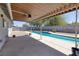 Covered patio provides shaded poolside lounging with a ceiling fan at 616 Fernbrook Dr, Henderson, NV 89002