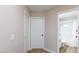 Hallway with doors leading to bathroom and other rooms, featuring clean lines and light neutral paint at 6337 Canyon Vista Ct, Las Vegas, NV 89156