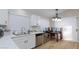 Bright kitchen featuring white cabinets, stainless steel appliances, and natural light, perfect for cooking and dining at 6337 Canyon Vista Ct, Las Vegas, NV 89156