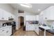 Modern kitchen featuring stainless steel appliances, ample counter space, and white cabinetry at 6337 Canyon Vista Ct, Las Vegas, NV 89156