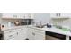 Bright kitchen features white cabinets, sleek countertops, stainless steel appliances, and lots of natural light at 6337 Canyon Vista Ct, Las Vegas, NV 89156