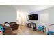 Spacious living area with wood-look floors, neutral walls, comfortable seating, and large windows providing plenty of light at 6337 Canyon Vista Ct, Las Vegas, NV 89156