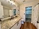 Granite vanity in a bathroom with a shower and walk-in closet at 6699 Oxendale Ave, Las Vegas, NV 89139
