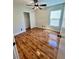 Bright bedroom with wood-look floors, a large window, and closet space offers comfort and functionality at 6699 Oxendale Ave, Las Vegas, NV 89139