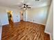 Spacious bedroom with wood-look floors, ceiling fan, and ample natural light at 6699 Oxendale Ave, Las Vegas, NV 89139