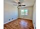Cozy bedroom featuring wood-look flooring, a ceiling fan, and a bright window offering natural light at 6699 Oxendale Ave, Las Vegas, NV 89139