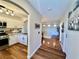 Hallway featuring wood floors, and an entryway to a bright kitchen and living room at 6699 Oxendale Ave, Las Vegas, NV 89139