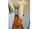 Inviting hallway with wood-look floors, neutral walls, and updated lighting, ready for your personal touches at 6699 Oxendale Ave, Las Vegas, NV 89139