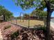 Community playground with swing set surrounded by green trees and landscaped yard at 6699 Oxendale Ave, Las Vegas, NV 89139